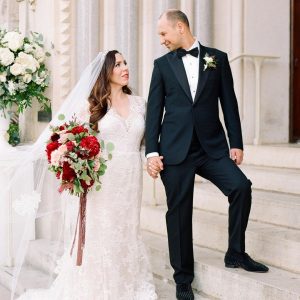 newly wed couple on stairs of venue