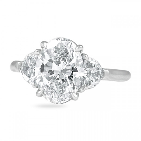 oval three-stone ring with half moon sidestones